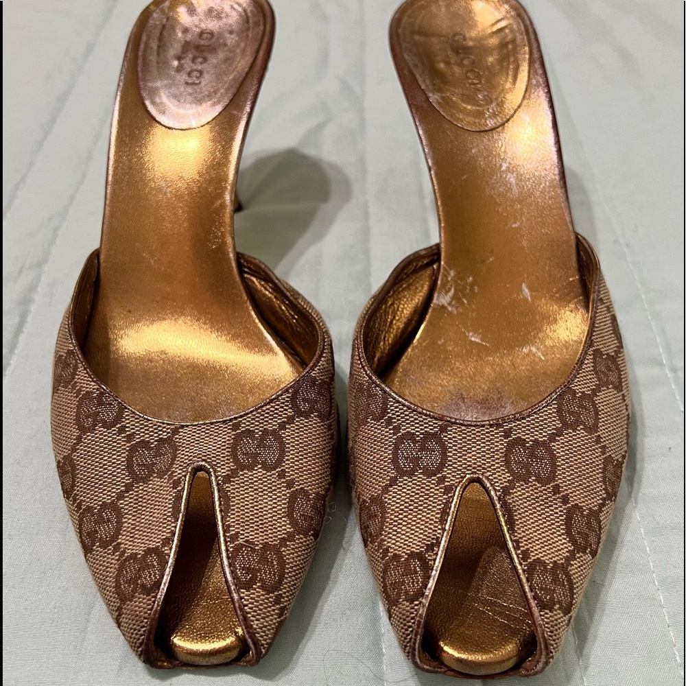 Gucci Peep
Toe
Monogram GG
Canvas and
Gold Studded
Heel Mules